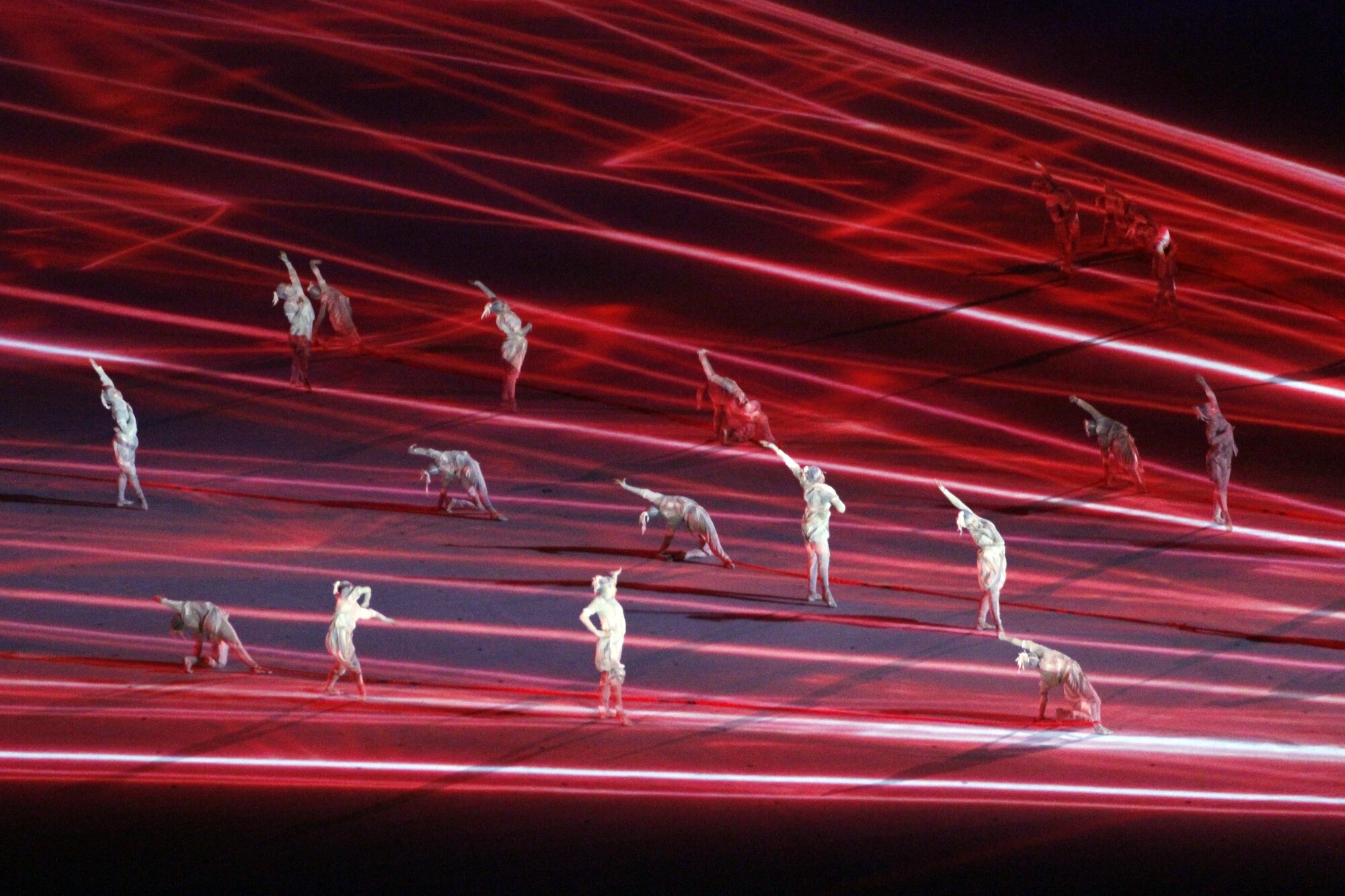 Dancers perform with projected lights during the opening ceremony of the Tokyo Olympics.