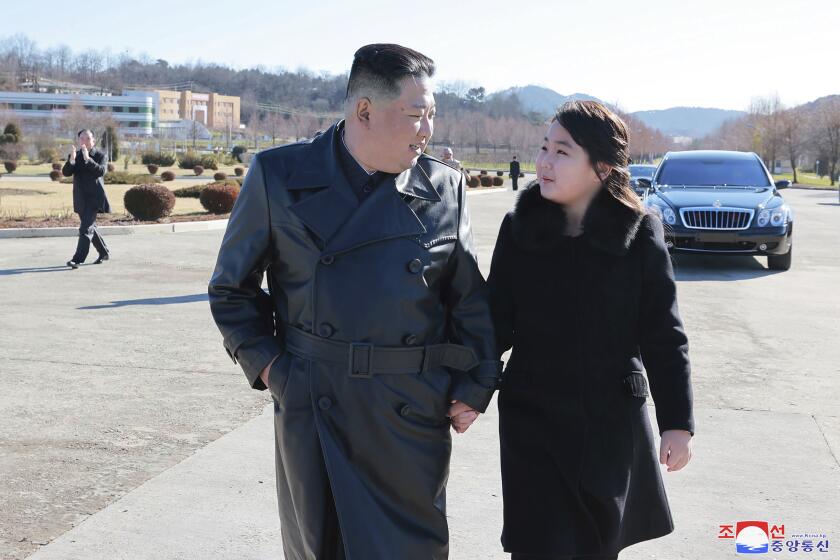 This undated photo provided on Nov. 27, 2022, by the North Korean government shows North Korean leader Kim Jong Un, left, and his daughter, right, walk to a photo session with those involved in the recent launch of what it says a Hwasong-17 intercontinental ballistic missile, at an unidentified location in North Korea. Independent journalists were not given access to cover the event depicted in this image distributed by the North Korean government. The content of this image is as provided and cannot be independently verified. Korean language watermark on image as provided by source reads: "KCNA" which is the abbreviation for Korean Central News Agency. (Korean Central News Agency/Korea News Service via AP)