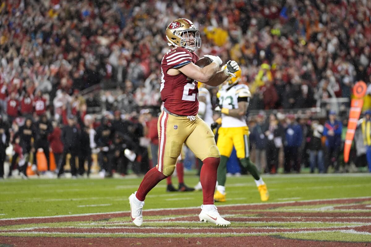 San Francisco 49ers running back Christian McCaffrey scores a touchdown during the second half Saturday.