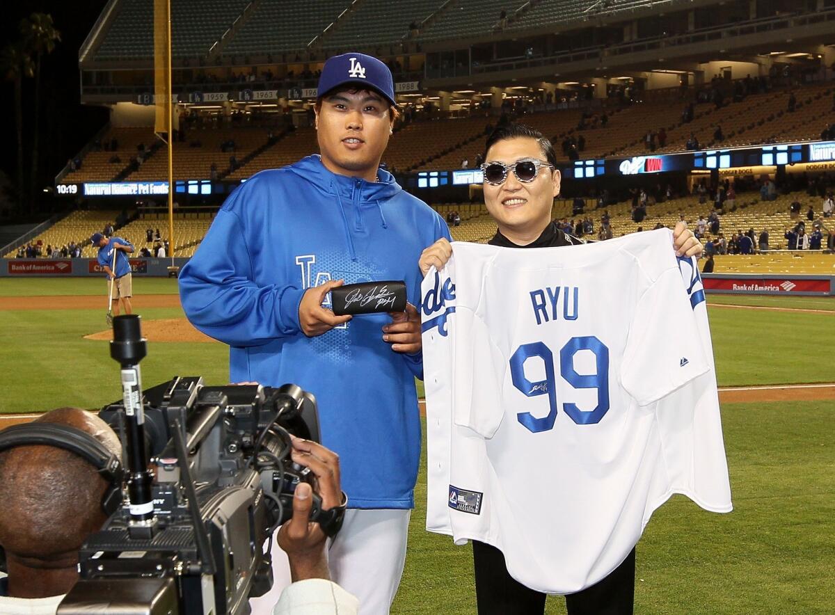 Dodgers pitcher Hyun-Jin Ryu and pop star Psy, both from South Korea, exchanged gifts following Tuesday night's game against the Colorado Rockies.