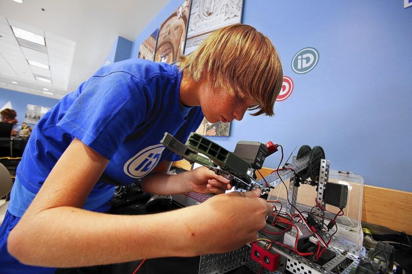 Rice Province works on robotics during an iD Tech Programming Academy at UCLA. Computer coding is becoming more popular among U.S. kids hoping to get in to better schools or improve career prospects.