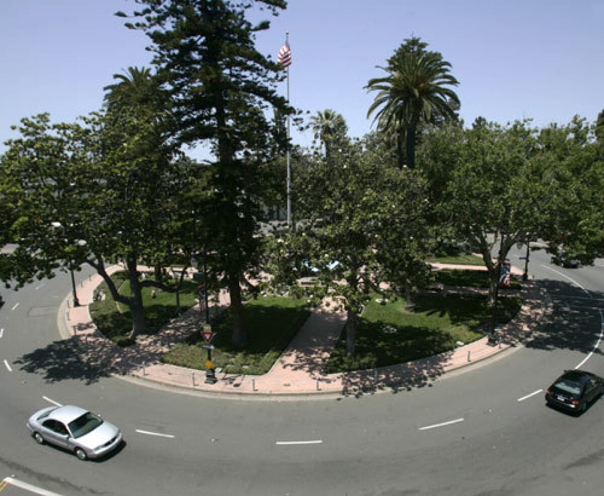 Cars make their way around the traffic circle at Orange Plaza in Historic Old Towne Orange. Many people still refer to the area as the Orange Circle. It is off Chapman Ave. and branches off to Glassell St. The traffic was moving on a Wednesday May 28, 2008. The view is seen from atop the Wells FArgo Bank.