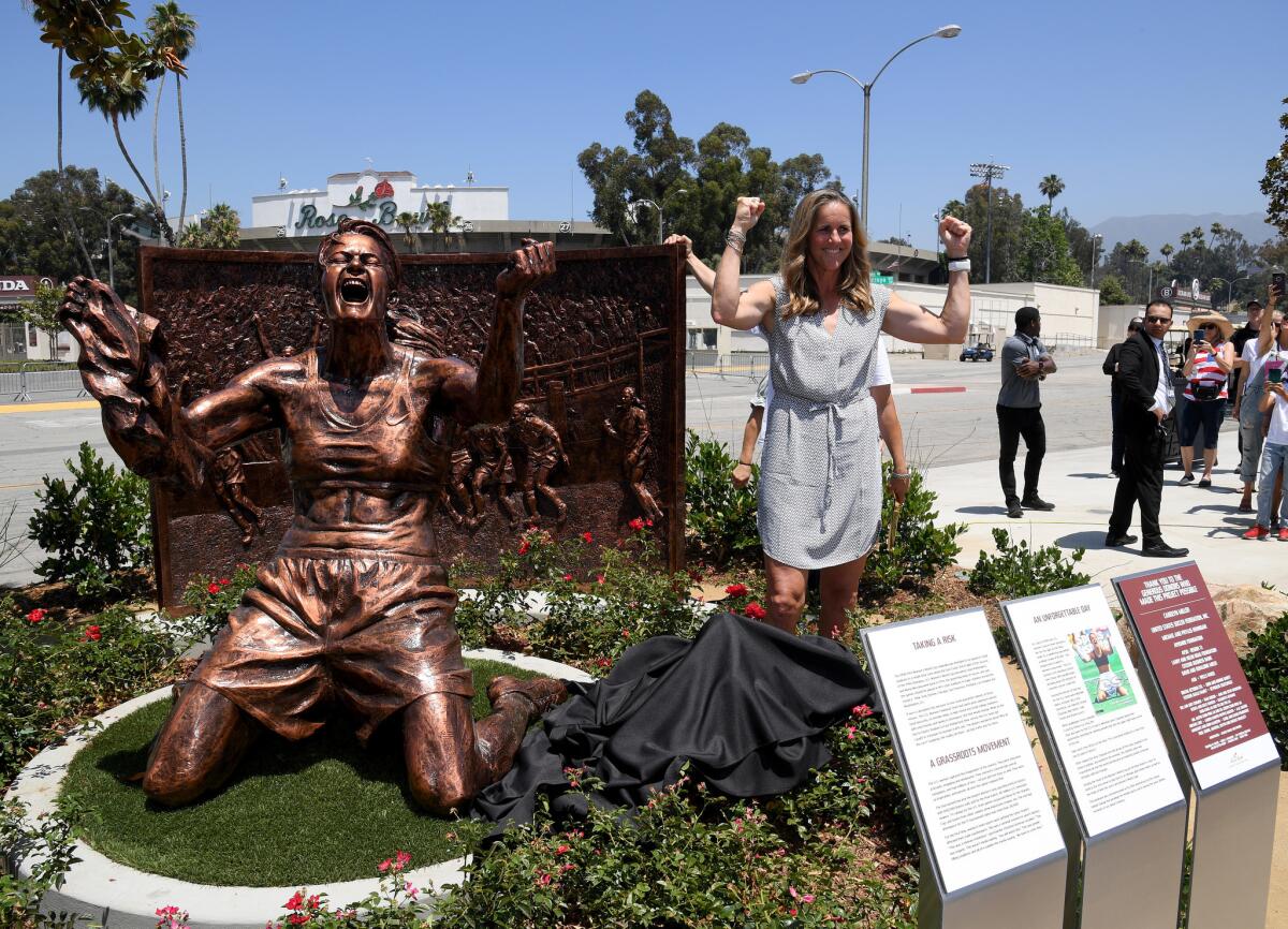 Brandi Chastain poses with statue of herself during an unveiling of a statue honoring the United States win at 1999 Womens World Cup on July 10, 2019 at the Rose Bowl in Pasadena, California.