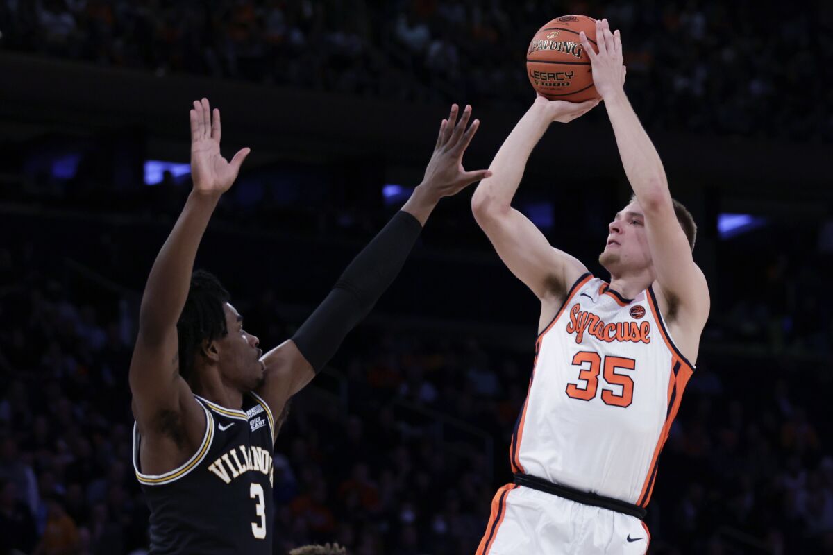 Syracuse guard Buddy Boeheim (35) shoots over Villanova forward Brandon Slater during the first half of an NCAA college basketball game in the Jimmy V Classic on Tuesday, Dec. 7, 2021, in New York. (AP Photo/Adam Hunger)