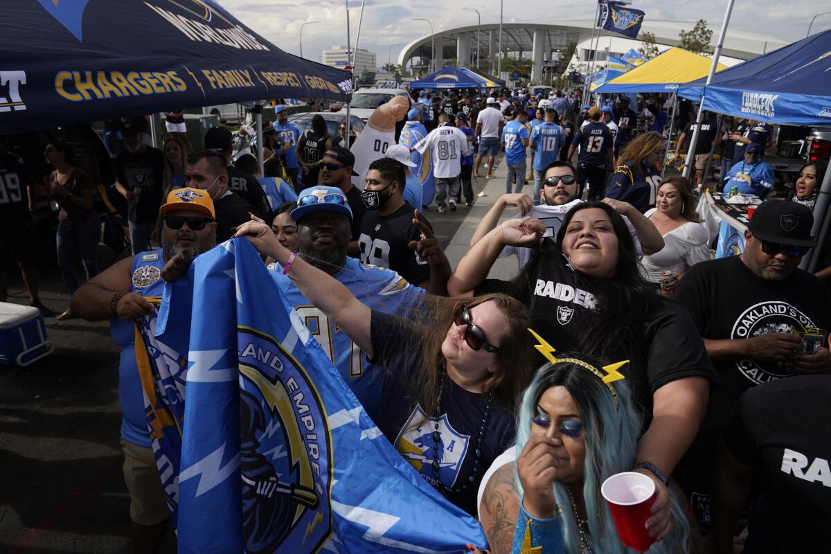 Los Angeles Chargers fans look on in front of SoFi stadium  