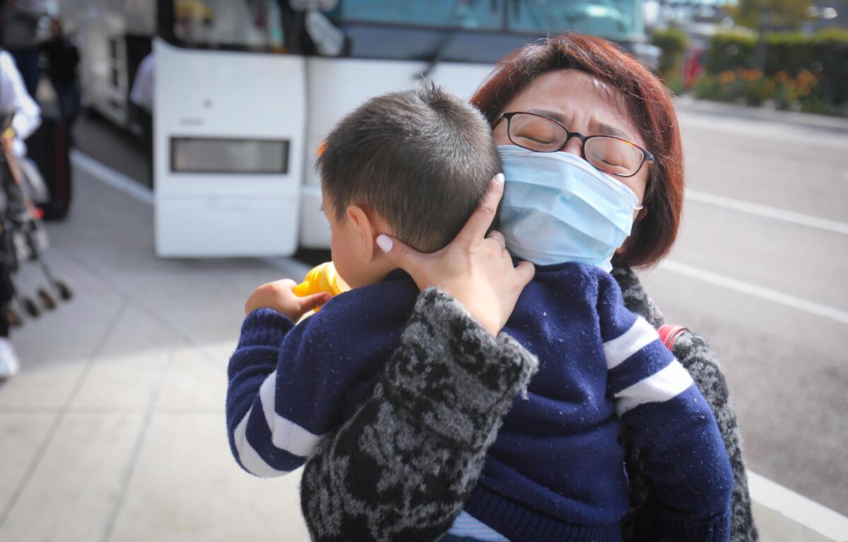 A bus transporting coronavirus evacuees from Marine Corps Air Station Miramar leaves the base this week.