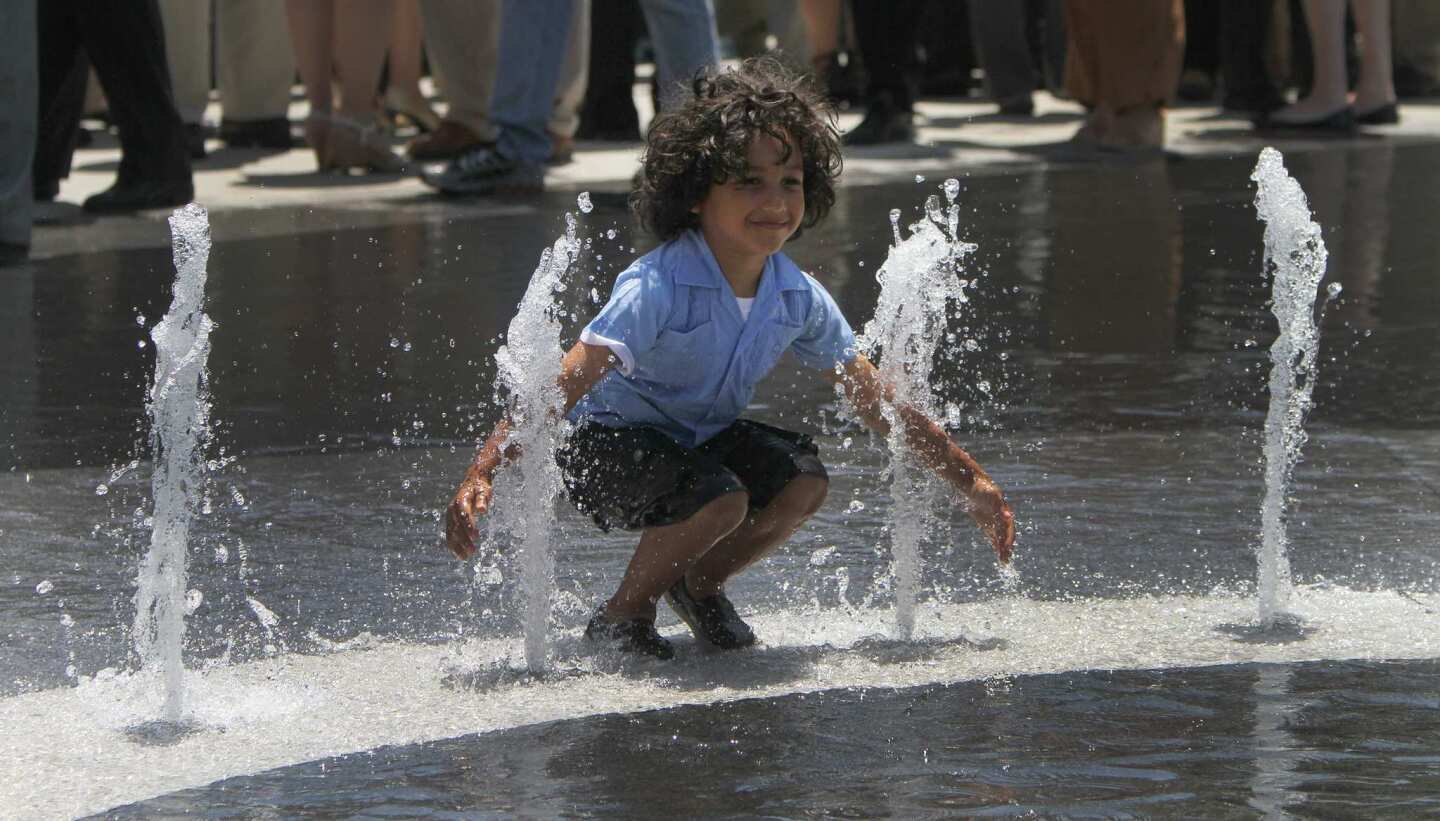 Lucas Rivera, 4, of Los Angeles cools off in the wading pool at Grand Park.