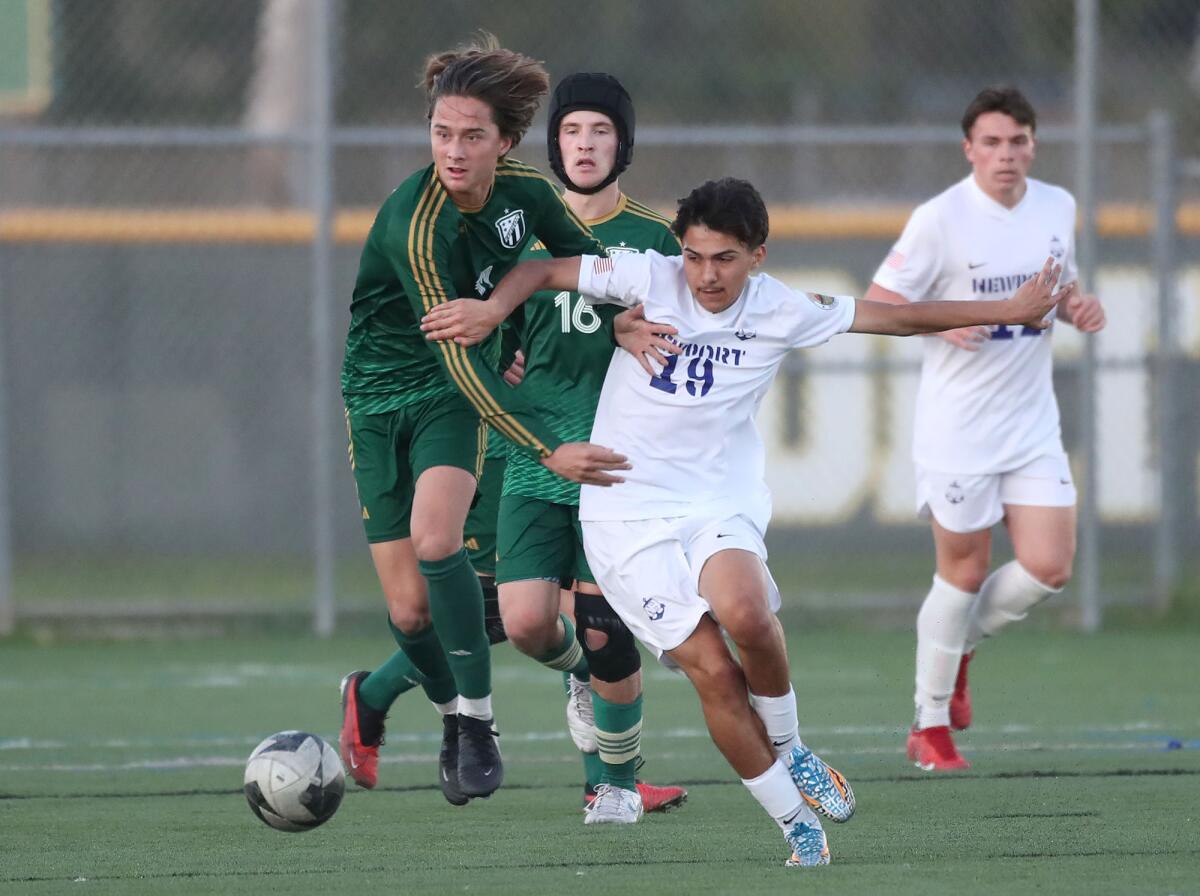 Edison's Micah Novak (11) and Newport Harbor's Oswaldo Portillo (19) battle for a ball at midfield on Monday.