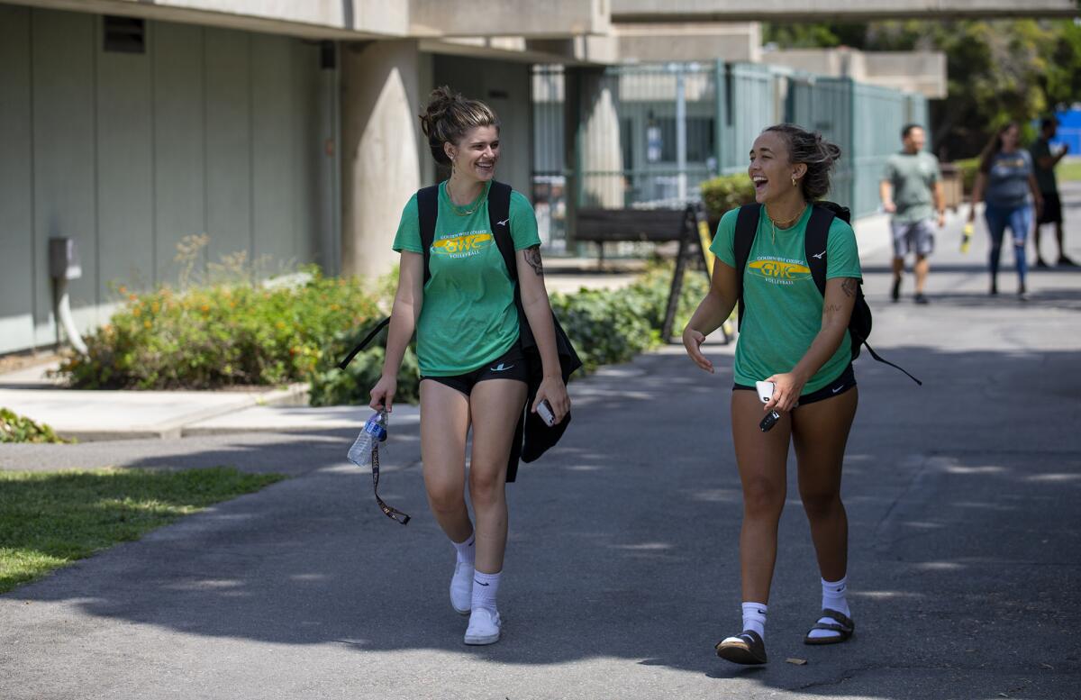 Volleyball players Dallas Smulson, left, and Kate Griffin walk through campus at Golden West College on Monday, Aug. 30.