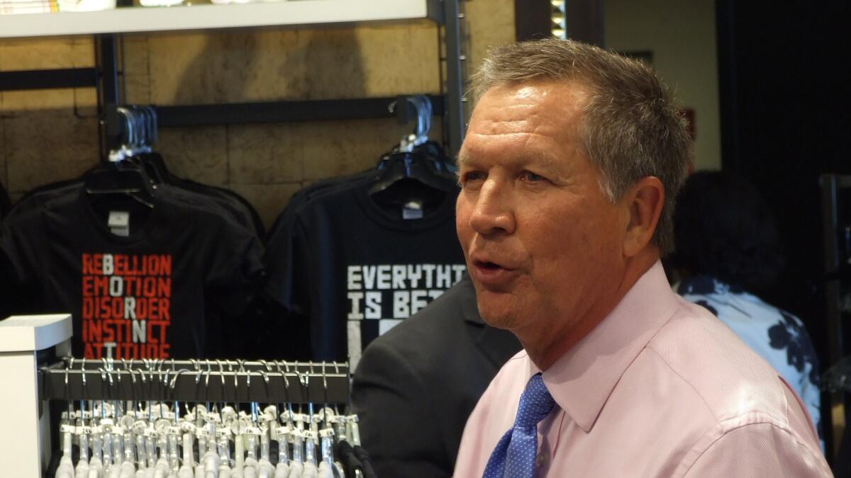 Ohio Gov. John Kasich takes a private moment in the gift shop of Cleveland's Rock & Roll Hall of Fame & Museum.