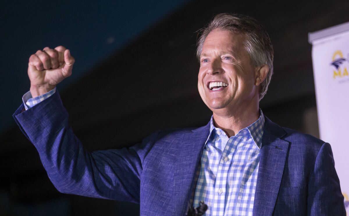 Roger Marshall pumps his fist after defeating Kris Kobach in the Republican primary for U.S. Senate.