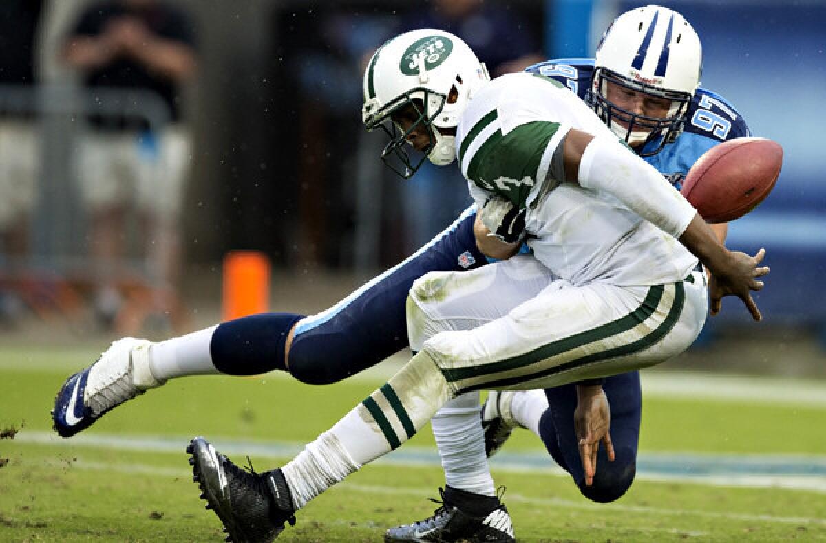 Jets quarterback Geno Smith has the ball stripped from him by Titans defensive lineman Karl Klug during their game Sunday. Smith has 11 turnovers in four games, tied with the Giants' Eli Manning for most in the NFL so far this season.