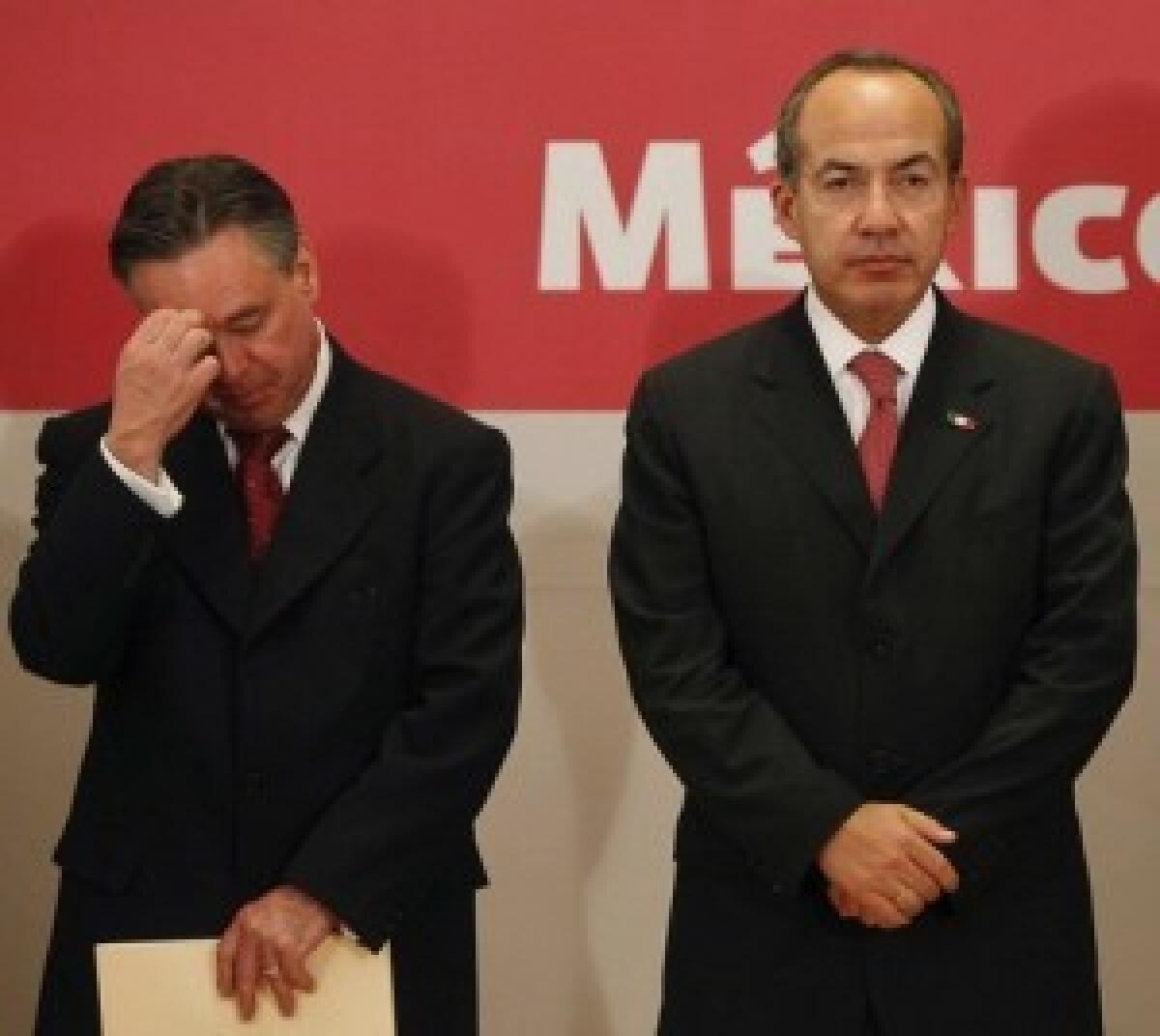 Eduardo Medina Mora, left, stands with President Felipe Calderon as he announces his departure. Medina Mora was Calderons point man on the drug war.