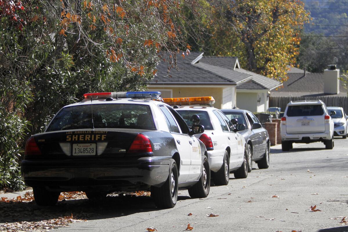 Los Angeles County Sheriff's vehicles are seen parked across from a home after a robbery on the 1000 block of Fairview Dr. in La Cañada Flintridge on Thursday, Jan. 15, 2015.
