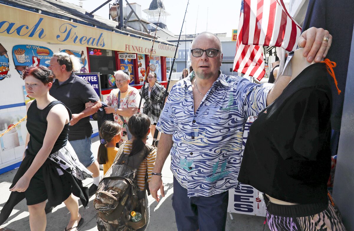 Tony George, owner of Surfside Pick Your Print gift shop on the Balboa Boardwalk Thursday.