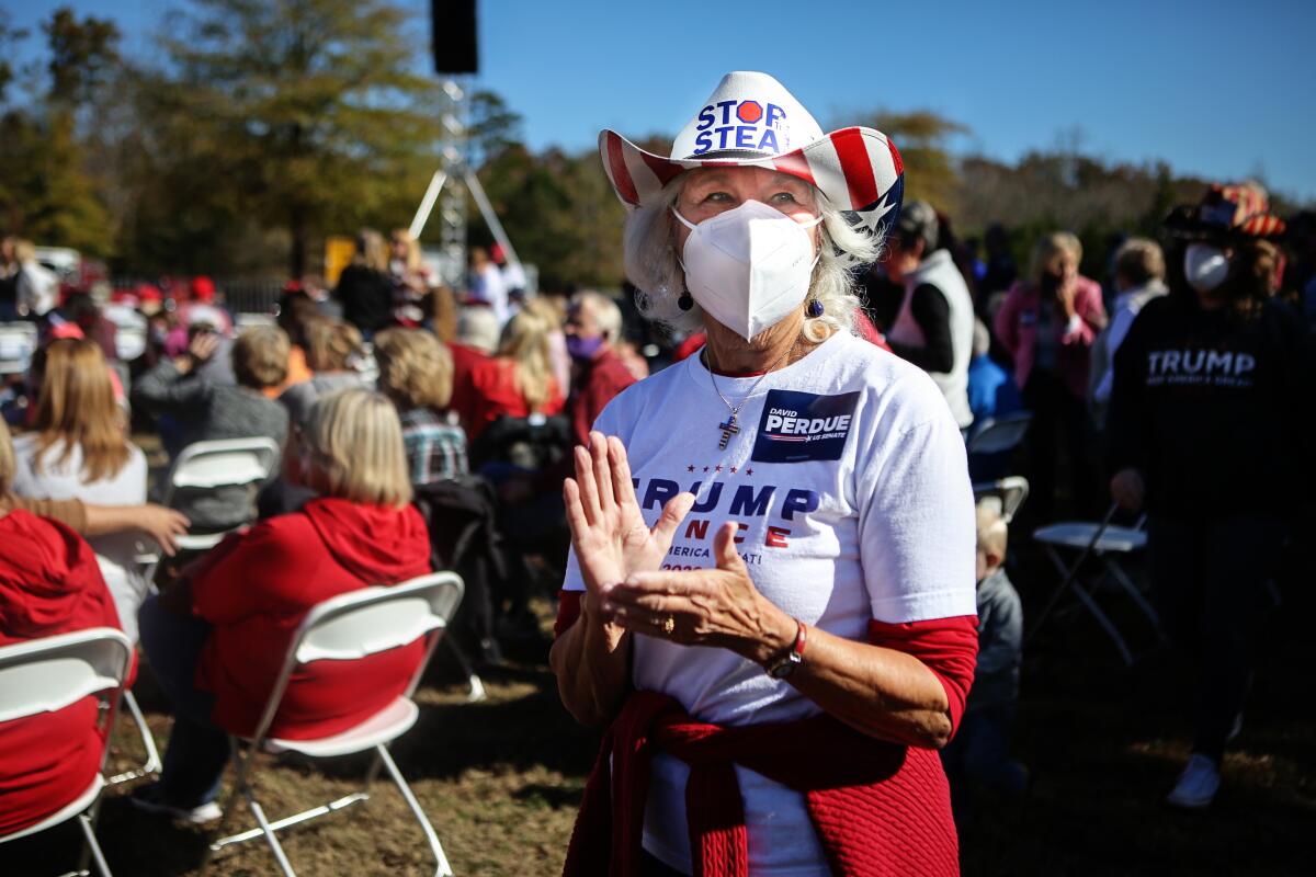 A Republican supporter wearing a "Stop the Steal" hat attends the rally.