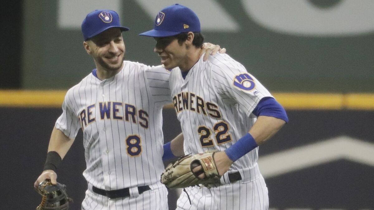 The Brewers' Ryan Braun and Christian Yelich celebrate after a game against the Detroit Tigers.