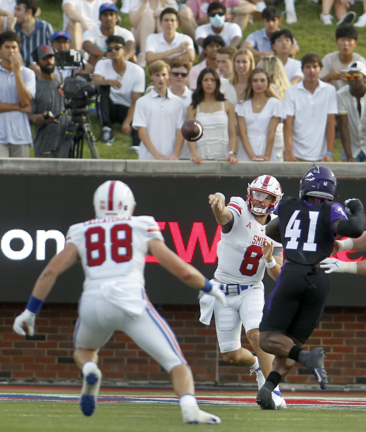 SMU quarterback Tanner Mordecai (8) throws a pass to tight end Grant Calcaterra (88) as Abilene Christian defensive lineman Tyrin Bradley (41) closes in during during the first quarter of an NCAA college football game Saturday, Sept. 4, 2021, in Dallas. (Steve Hamm/The Dallas Morning News via AP)