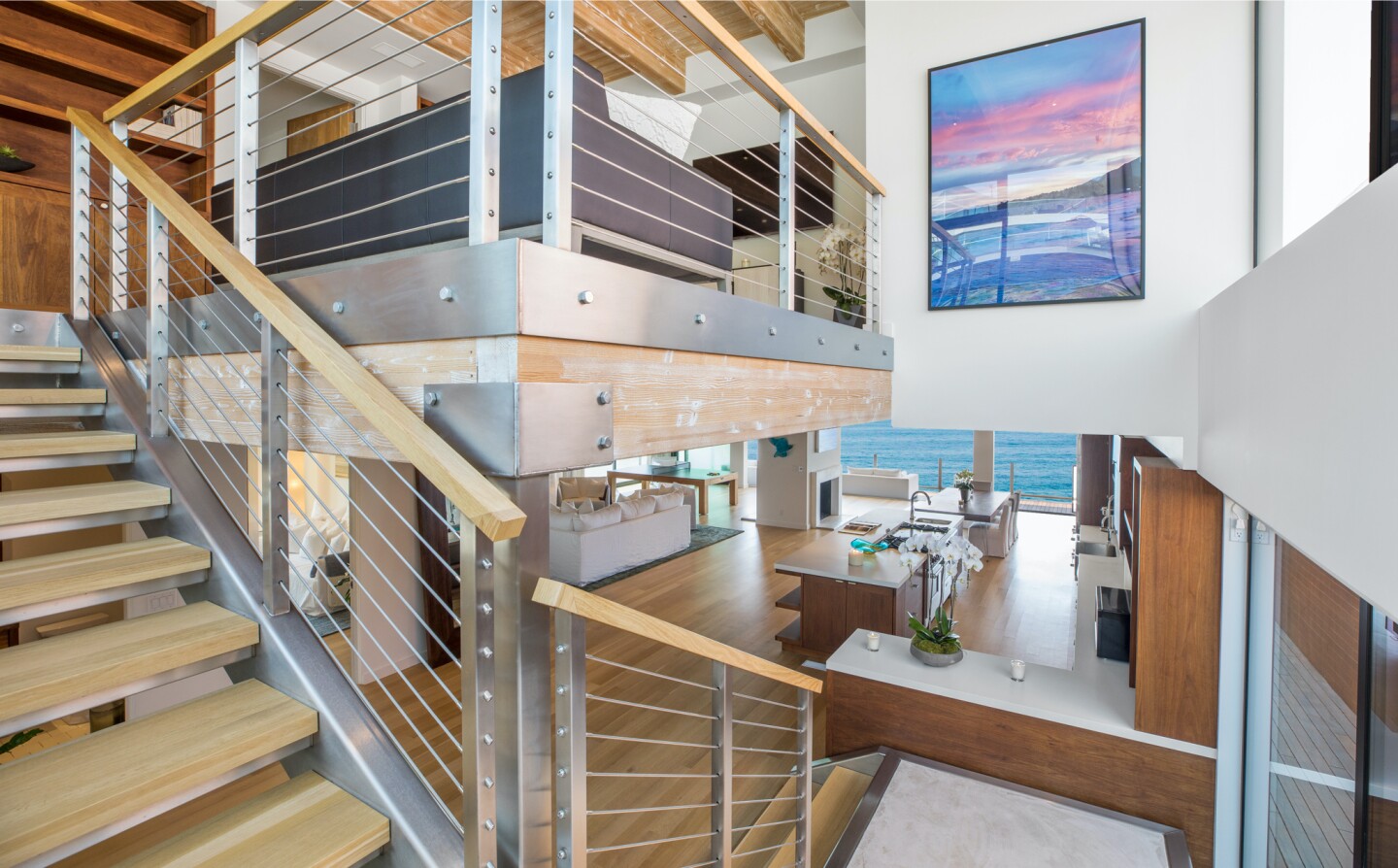 The architectural beach house expands to two levels of wood decks overlooking the ocean.