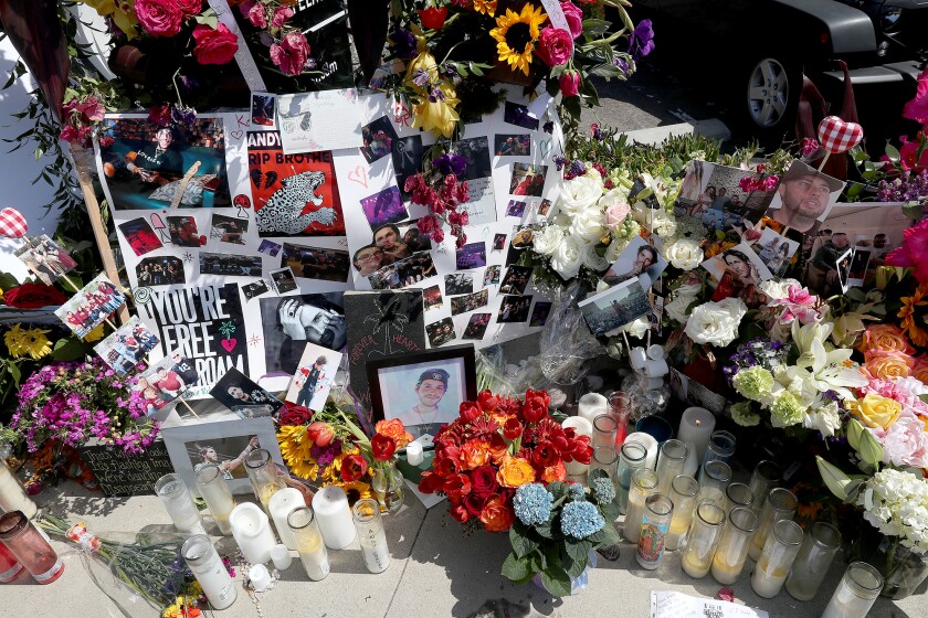 A sidewalk shrine marks the spot on the West Coast Highway in Newport Beach where three people died in a May 12 vehicle collision.