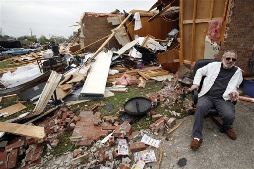 Tony Parkerson rests outside his damaged home the day after it was hit by a tornado in Murfreesboro, Tenn., Saturday, April 11, 2009. Severe storms that spawned tornadoes across the Southeast Friday have been blamed for three deaths and dozens of injuries. (AP Photo/Mark Humphrey)