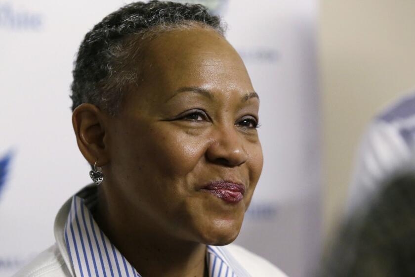 FILE - In this May 21, 2016, file photo, WNBA President Lisa Borders smiles as she speaks to reporters before a WNBA basketball game between the San Antonio Stars and the Dallas Wings in Arlington, Texas. TIMES UP has named Borders as its first president and CEO. In a statement Tuesday, Oct. 2, 2018, the organization said Borders will lead the organizations efforts to ensure equal opportunity and protection for all working women. (AP Photo/LM Otero, File)