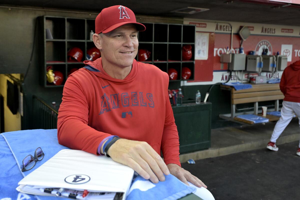 Los Angeles Angels interim manager Ray Montgomery sits in the dugout in Anaheim.