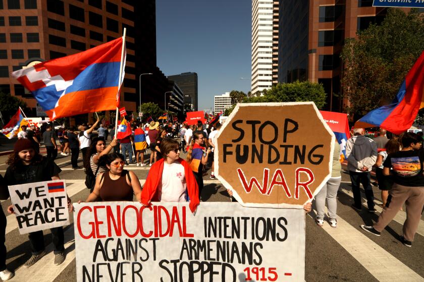 LOS ANGELES, CA - SEPTEMBER 17, 2022 - - Over a hundred demonstrators, with the Armenian Youth Federation, take over an intersection on Wilshire Blvd. to protest Azerbaijan's military action along the Armenia-Azerbaijan border in front of the Azerbaijani Consulate General's office in Los Angeles on Saturday, September 17, 2022. (Genaro Molina / Los Angeles Times)