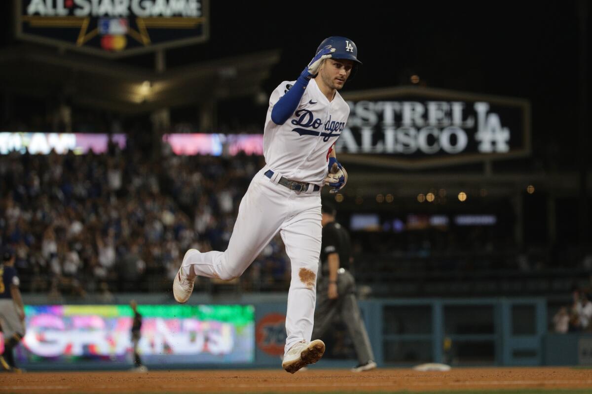 The Dodgers' Trea Turner runs the bases after hitting a tying grand slam in the fifth inning Friday.