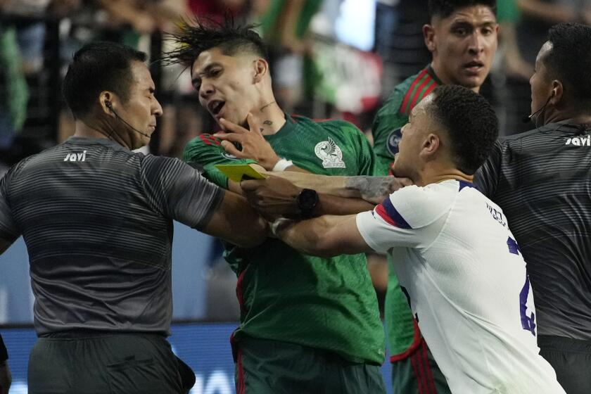 Sergino Dest of the United States pushes Gerardo Arteaga of Mexico during the second half of a CONCACAF Nations League semifinals soccer match Thursday, June 15, 2023, in Las Vegas. (AP Photo/John Locher)