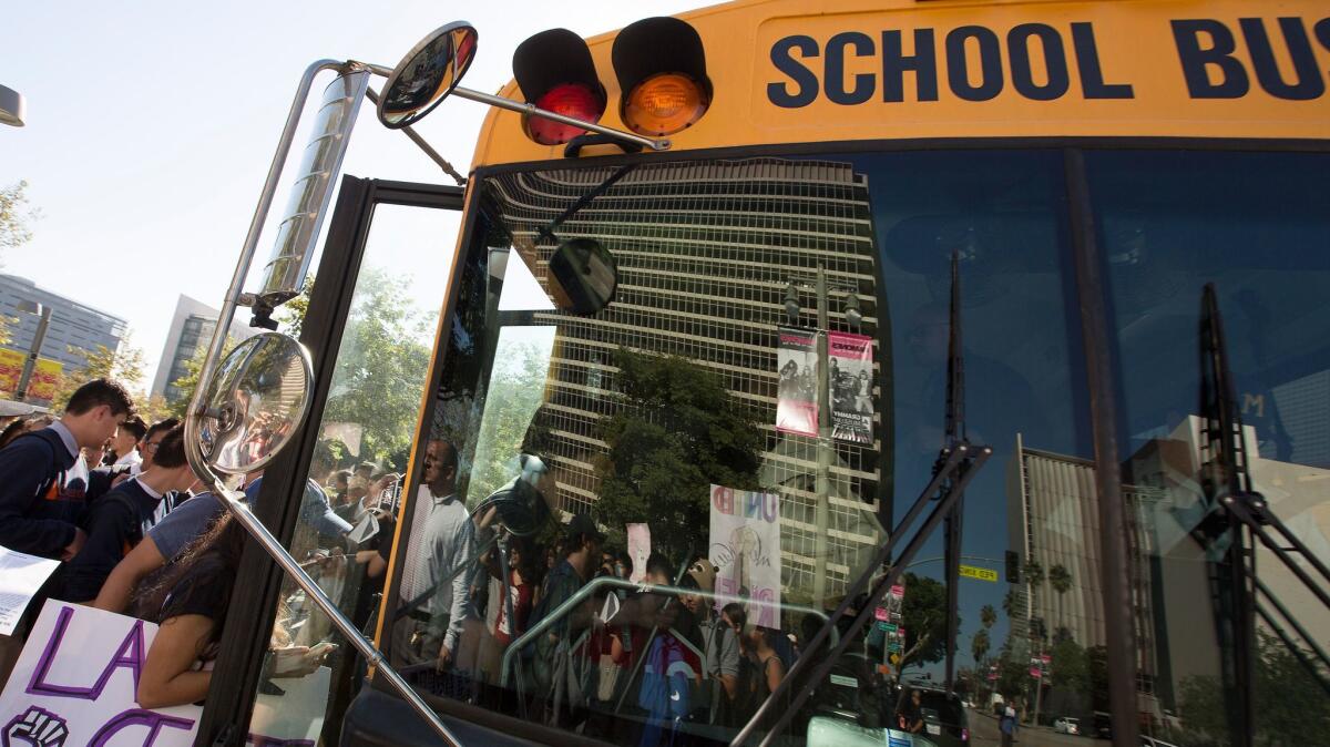 Students board a bus back to school after walking out of class and attending a march in downtown Los Angeles on Nov. 14, 2016.