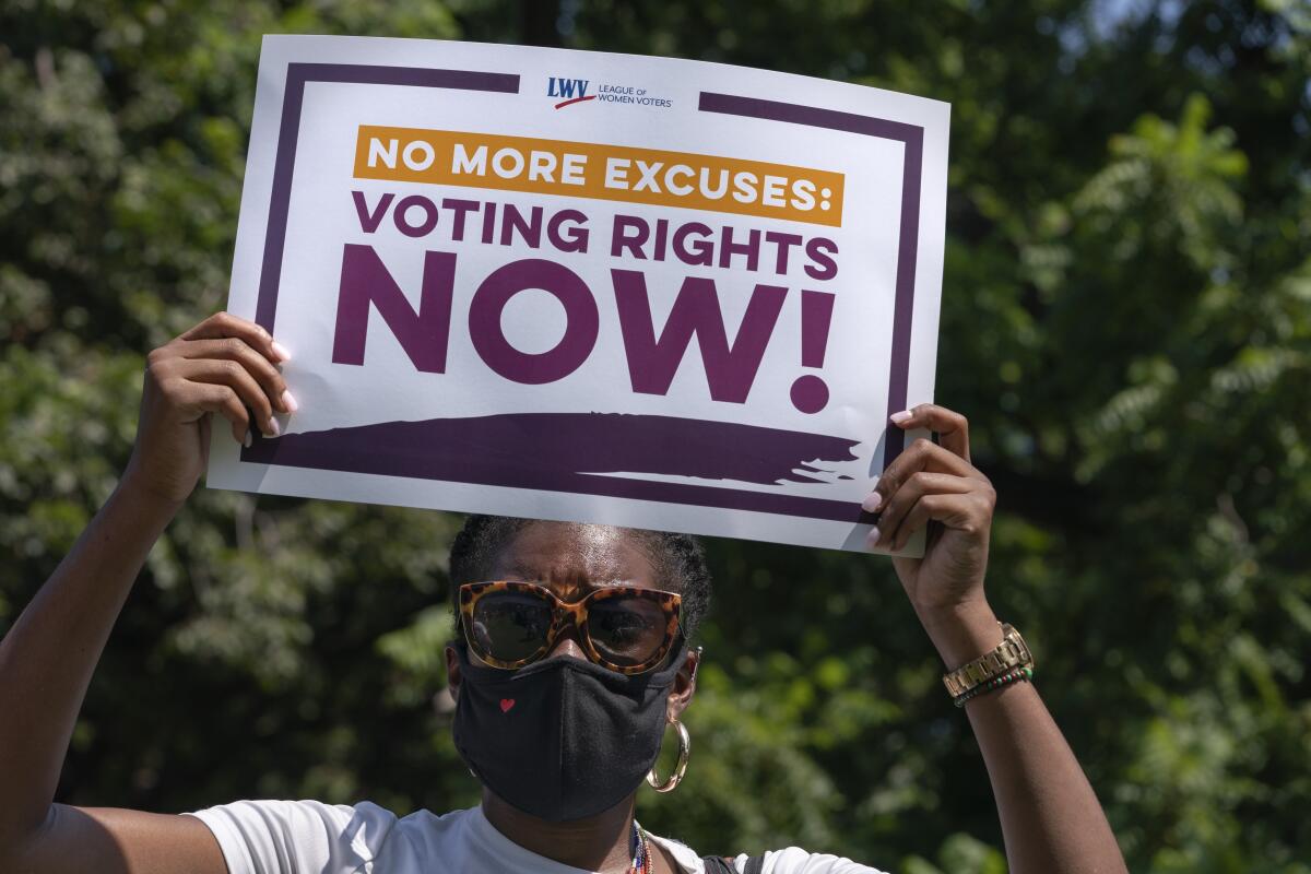 LaQuita Howard of Washington, with the League of Women Voters, attends a rally for voting rights.