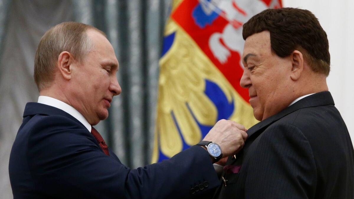 Russian President Vladimir Putin, left, presents Iosif Kobzon with the Hero of Labor medal in 2016.