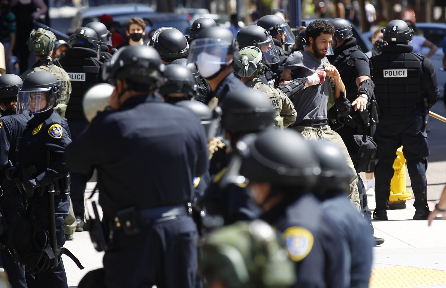 A protester is taken into custody by San Diego police in downtown San Diego on May 31, 2020. The group was protesting the death of George Floyd.