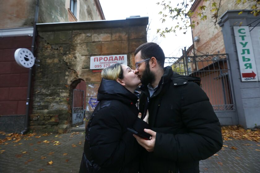 Kherson, Ukraine-Nov. 20, 2022--Ludmila Taranov, 31, met Viacheslav Slavov, also 31, one month before the Russian invasion of Kherson. "It seems like 10 years," said Lucy about their 10 month relationship. They are planning to get married as soon as the Ukrainian government offices are operating again. But for now, the Russians continue to bomb Kherson. (Carolyn Cole / Los Angeles Times)