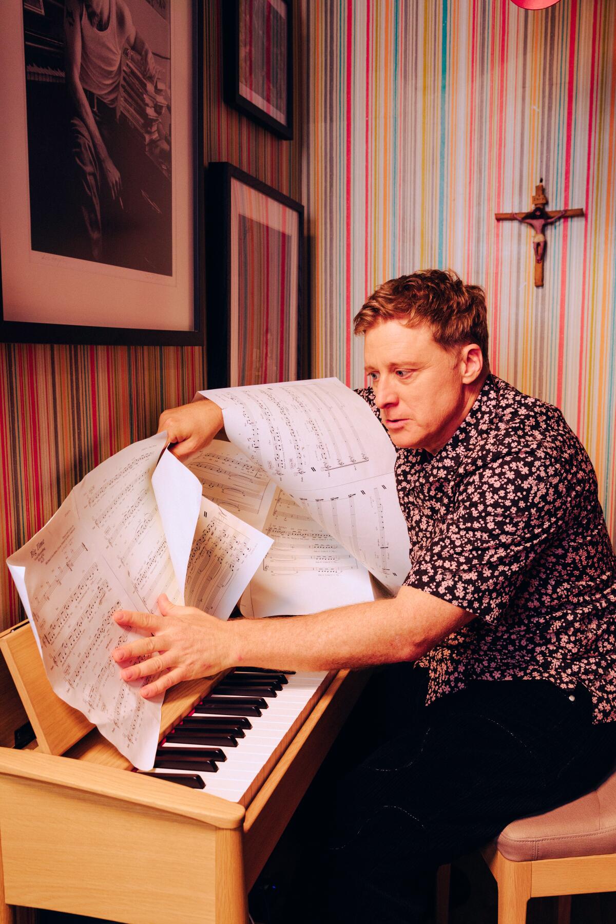 Alan Tudyk gets a little dirty with the sheet music on his home piano.