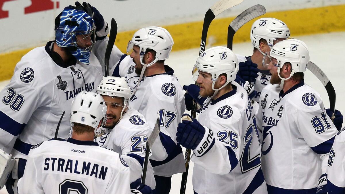 Tampa Bay Lightning goalie Ben Bishop, left, celebrates with his teammates after their 3-2 victory over the Chicago Blackhawks in Game 3 of the Stanley Cup Final on June Monday.