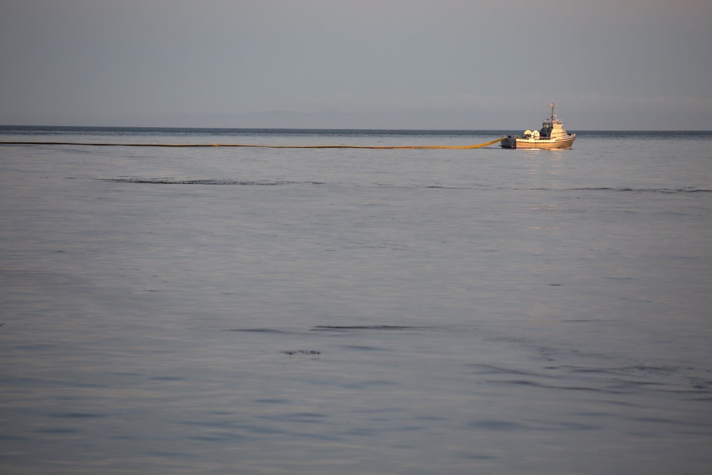 Boom ships work to contain oil offshore at Refugio State Beach just north of Santa Barbara.