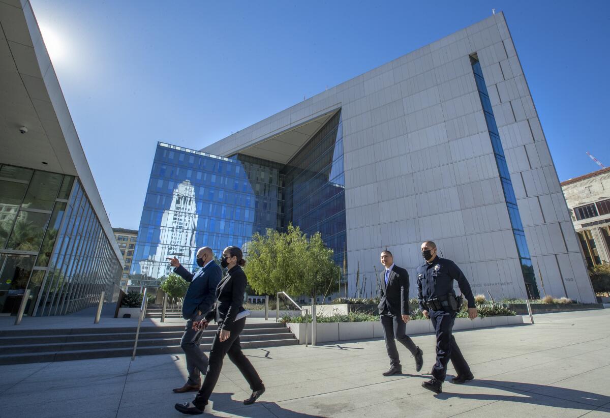 Officers walk past LAPD headquarters