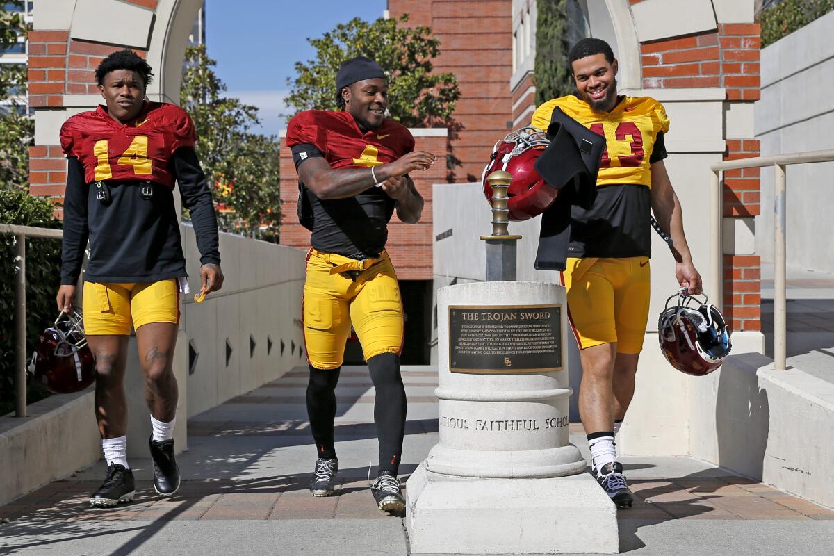 USC running back Raleek Brown, wide receiver Mario Williams and quarterback Caleb Williams walk together.