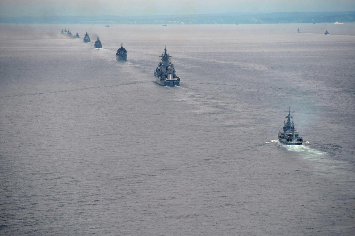 Russian Pacific Navy ships sail near Sakhalin Island during military exercises in July 2013. In spite of looming recession, Russia has significantly increased its defense budget this year to speed up production of new aircraft, tanks, missiles and warships.