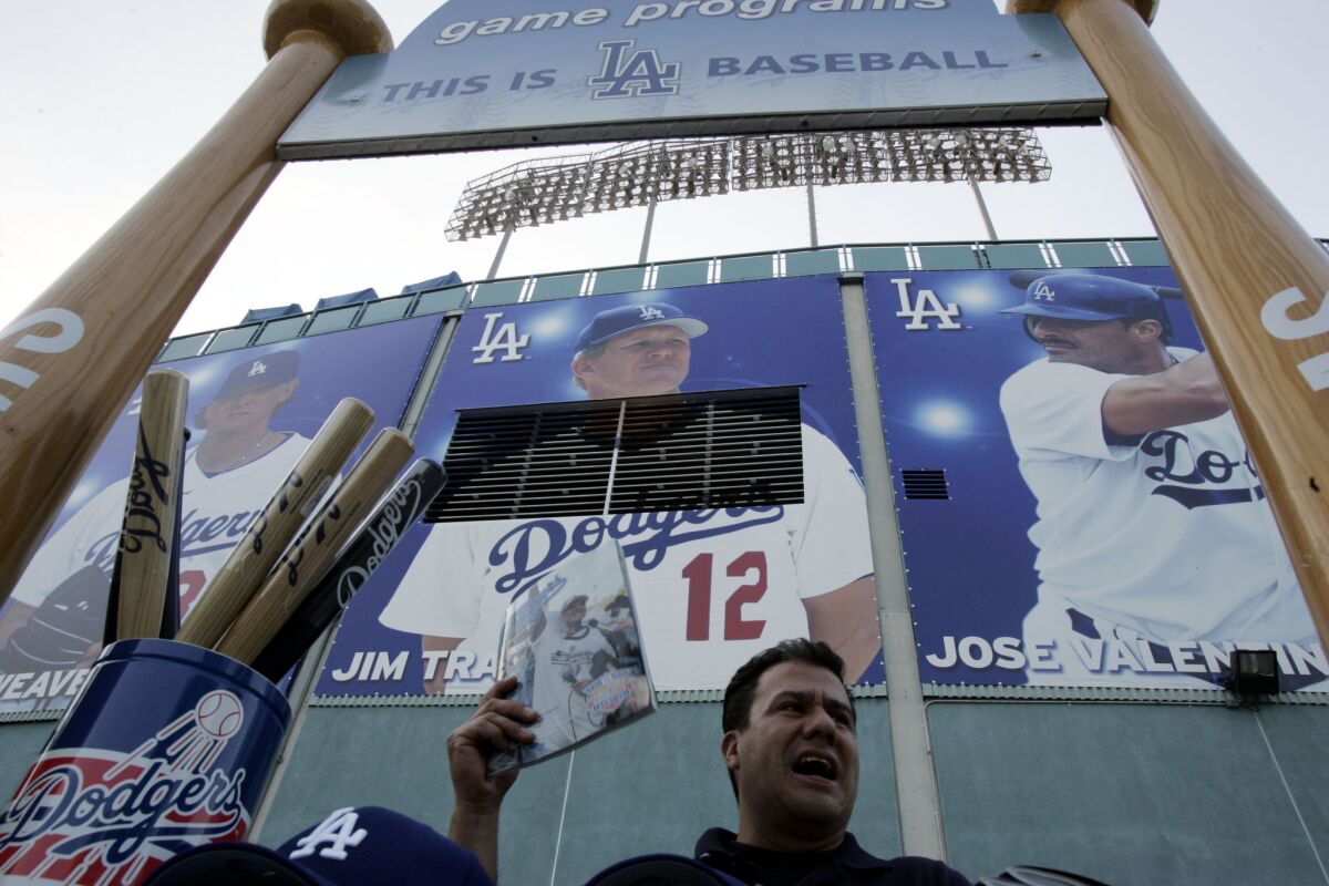 Dodgers employee Mario Olmos sells programs at Dodger Stadium in 2005.