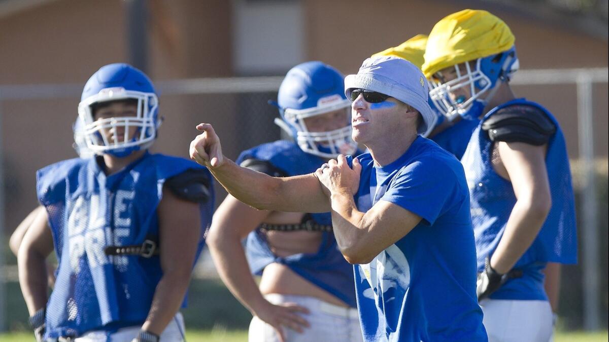 Fountain Valley High coach Jimmy Nolan, shown running his players through drills on Aug. 15, 2017, says he hasn't put much thought into the CIF Southern Section dropping the Barons to the Division 8 playoffs for the upcoming 2018 season.