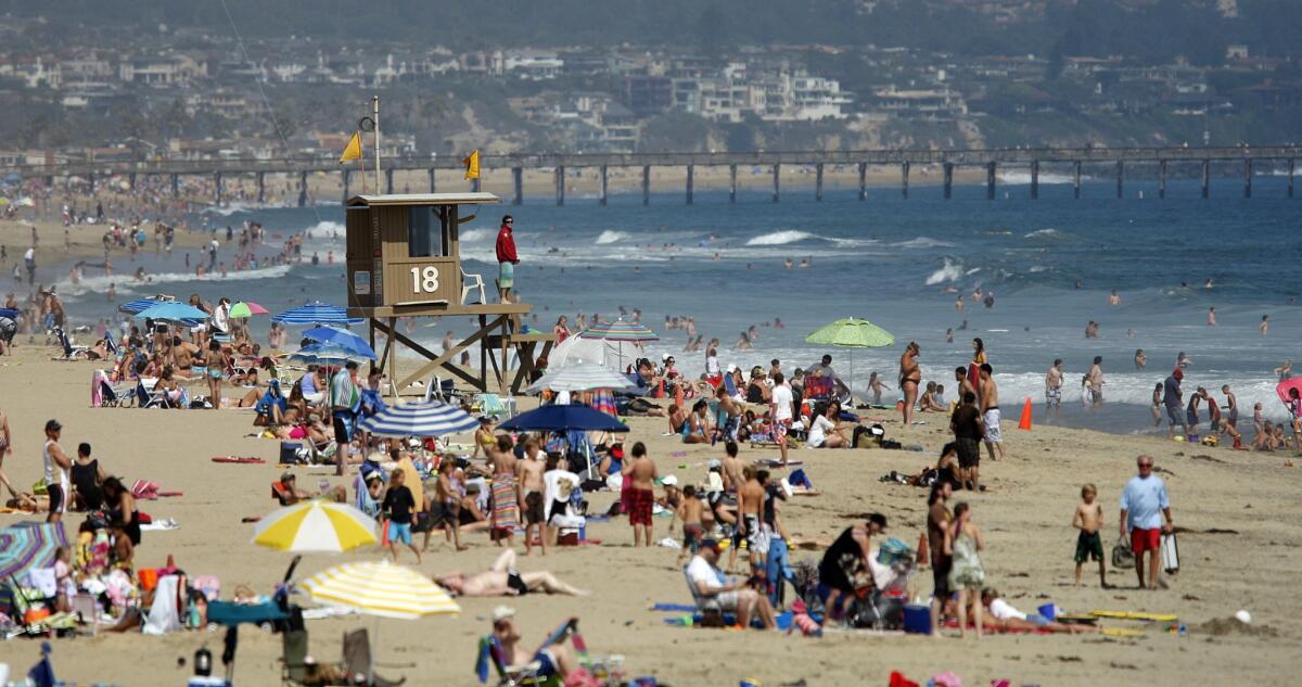 Crowds are common in Newport Beach on the Fourth of July. Above, beachgoers near the Newport Pier in 2010.