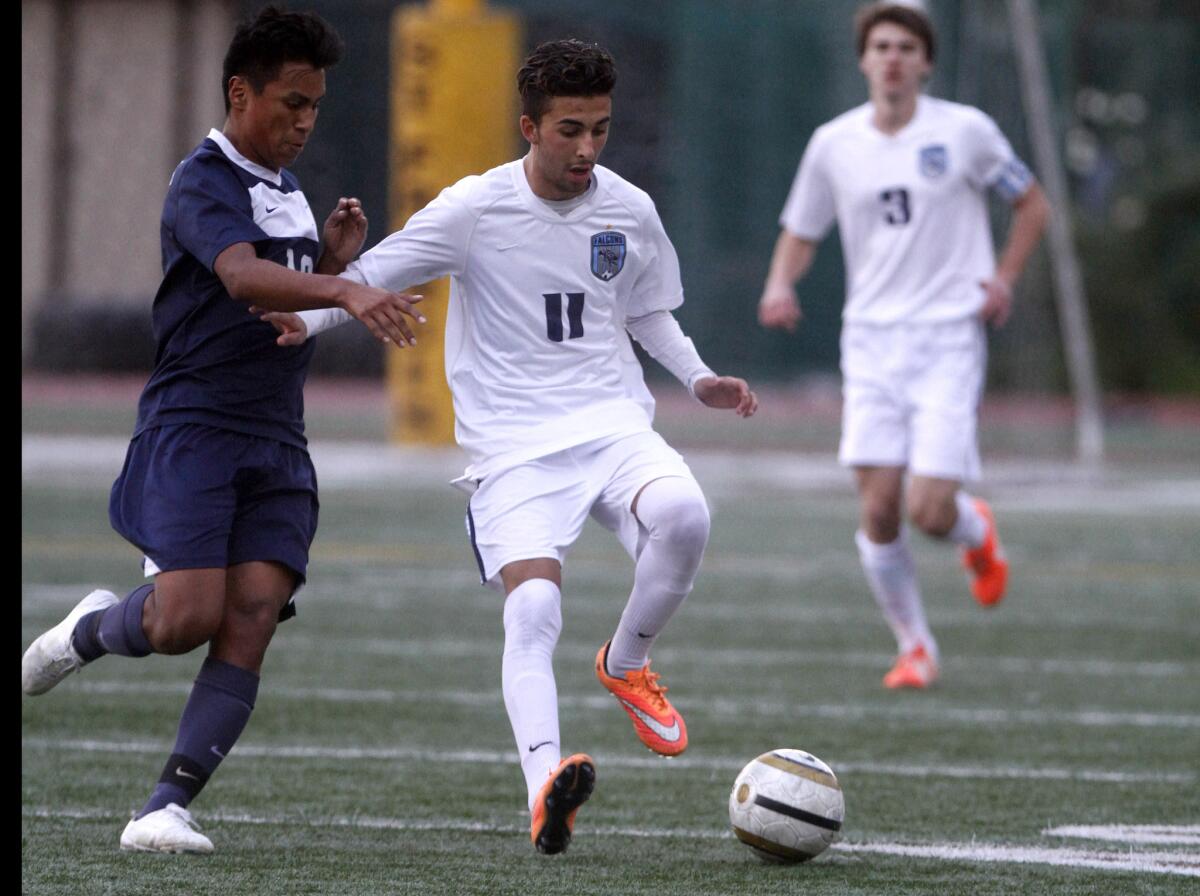 Crescenta Valley High School's #11 Jason Winicki battles for the ball in game vs. Sylmar High School at St. Francis High School in La Cañada Flintridge on Friday, Dec. 12, 2014.