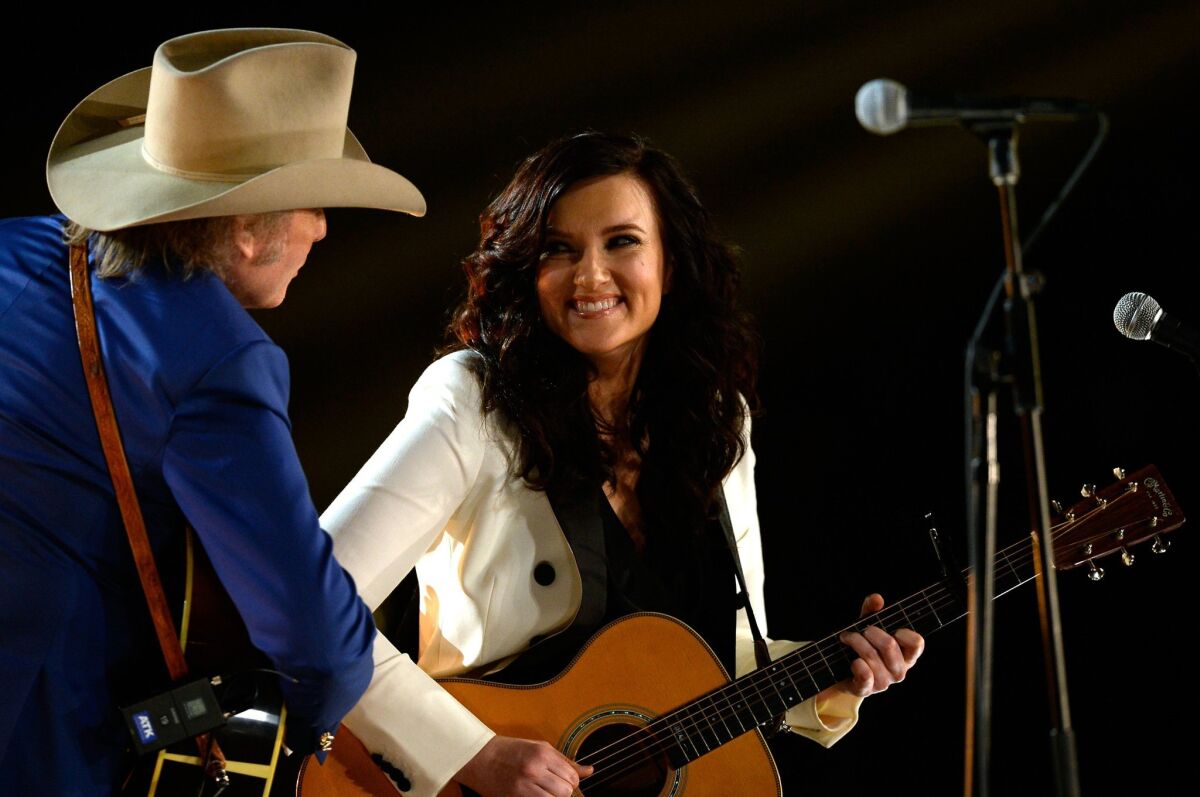 Brandy Clark and Dwight Yoakam perform "Hold My Hand" at the Grammy Awards show on Feb. 8.
