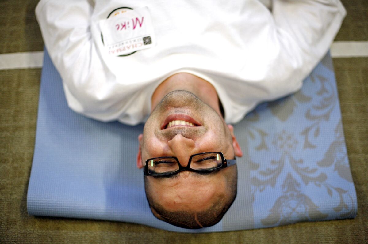 Mike Nojavan, who was 34 when he suffered a hemorrhagic stroke in 2011, relaxes at the end of a yoga class at Chapman University's Stroke Boot Camp. "The life I had before my stroke? I knew I couldn't get that life back. So I decided to get a life I could have," he says.