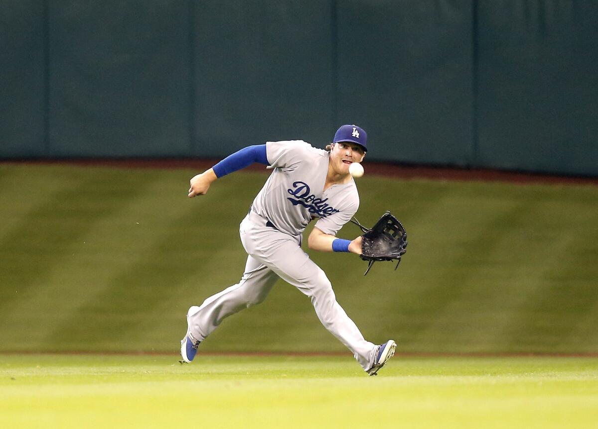 Dodgers outfielder Enrique Hernandez makes a running catch on a line drive hit by Astros second baseman Jose Altuve.