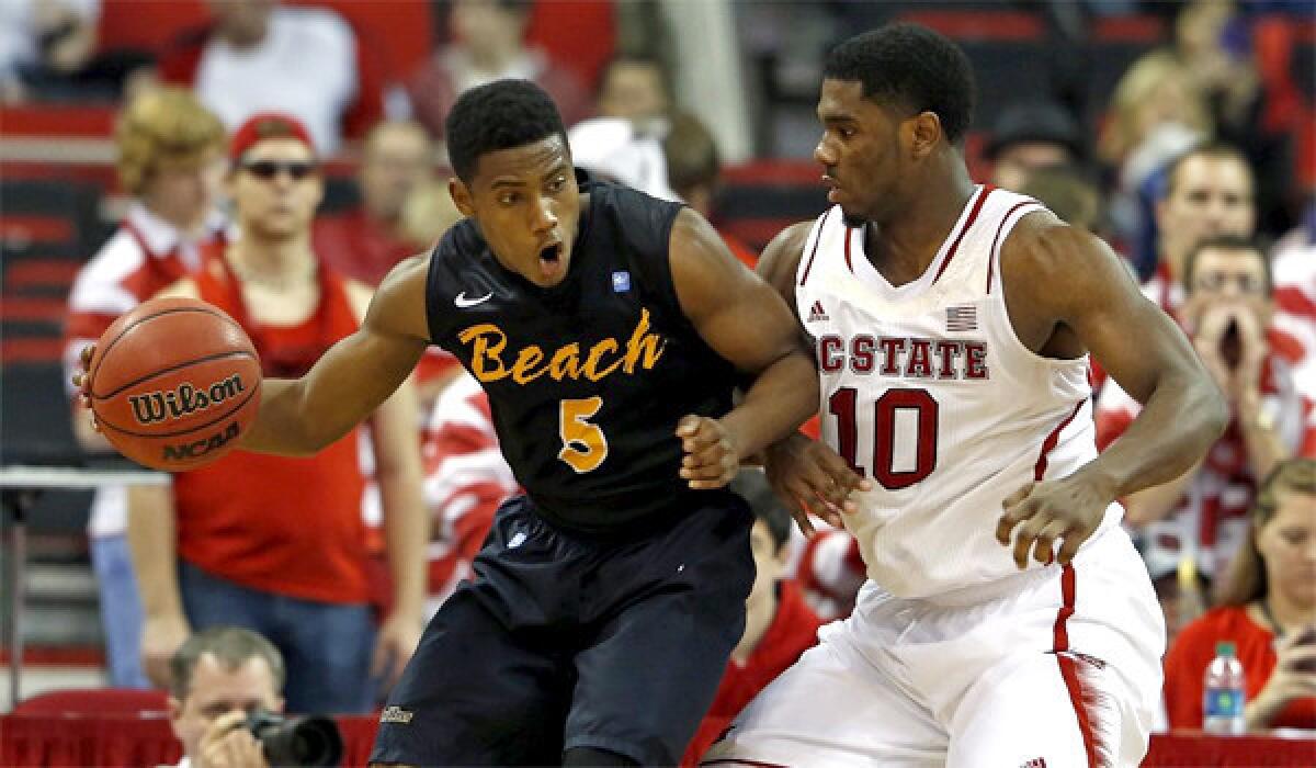 Junior guard Mike Caffey, Long Beach State's leading scorer, averaging 16 points per game, backs down N.C. State's Lennard Freeman on Dec. 7. The 49ers lost to the Wolfpack, 76-66.