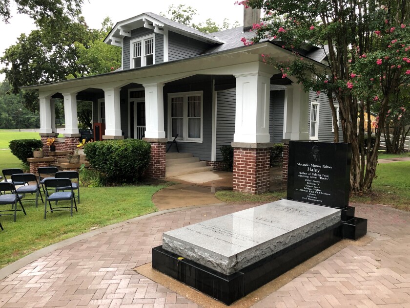 The grave of late author Alex Haley sits outside his former boyhood home on Friday, Aug. 13, 2021, in Henning, Tenn. The home is part of the Alex Haley Museum and Interpretive Center, which is honoring the writer of "Roots: The Saga of an American Family," on the 100th anniversary of Haley's birthday. (AP Photo/Adrian Sainz)